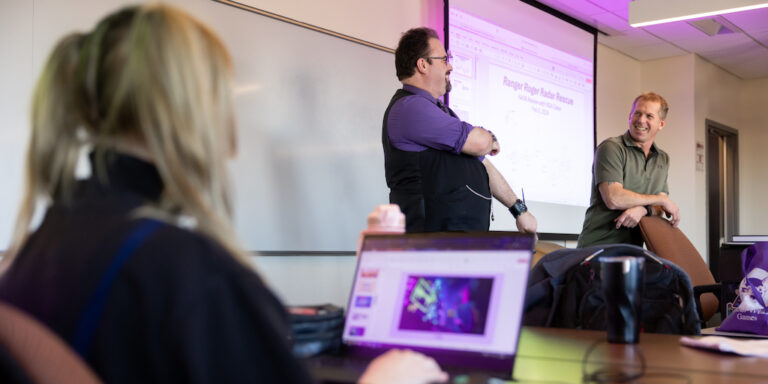 Mathew Powers (purple shirt), Lecturer with the Luddy School of Informatics, Computing, and Engineering, along with Todd Shelton (green shirt), co-teach the game design course at IUPUI. The photo was taken on Monday, Feb. 5, 2024. (Photo by Liz Kaye/Indiana University)