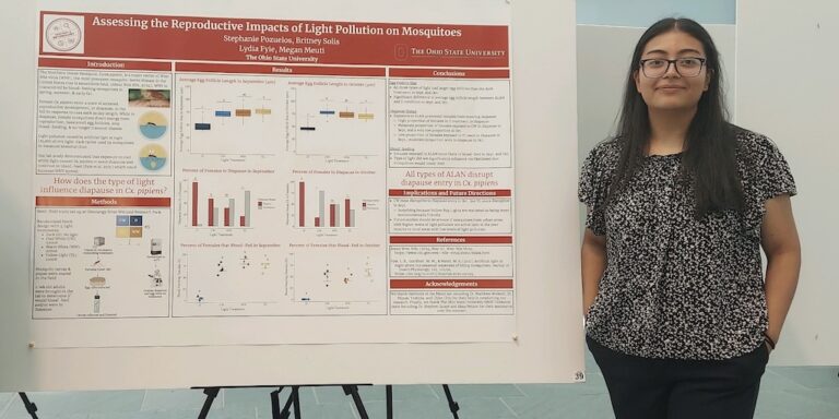 Biomedical Informatics student Stephanie Pozuelos stands next to her research poster