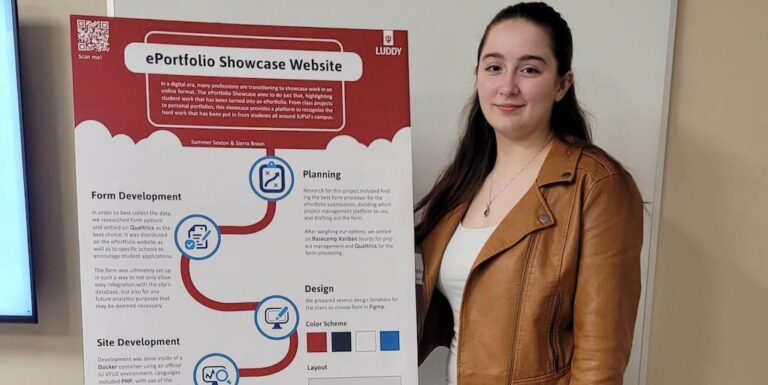 Student next to website poster